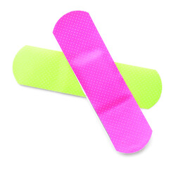 Green and pink medical plasters on white background