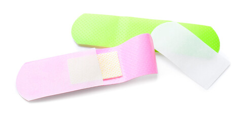 Green and purple medical plasters on white background