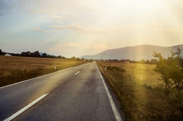 summer road with the sun rays