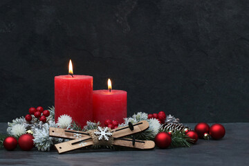 Rote Kerzen mit Weihnachtsschmuck.