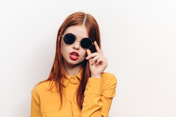 fashionable woman in yellow shirt sunglasses posing