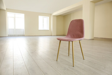 Pink chair in big empty office