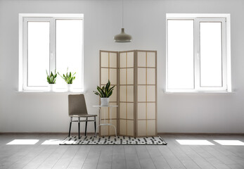 Interior of stylish room with folding screen
