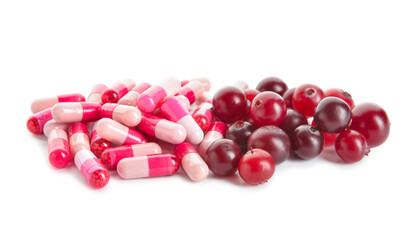 Heap of cranberry pills and berries isolated on white background