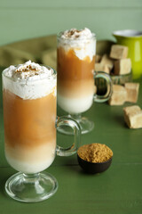 Glass cups of iced hojicha latte on table