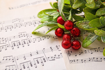 Rowan branch on note sheets, closeup. Christmas composition