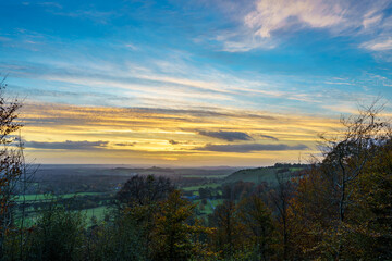 Naklejka na ściany i meble scenic Westerly view as the golden sun sets over Oare and across the Pewsey Vale valley, North Wessex Downs AONB