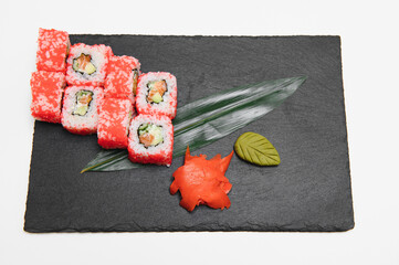 Japanese rolls on black background isolated with reflections