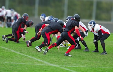 People Playing American Football on a green stadium