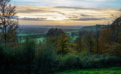 scenic Westerly view as the golden sun sets over Oare and across the Pewsey Vale valley, North Wessex Downs AONB