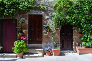 Old building in Pitigliano facade, with jars on the wall