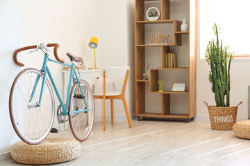 Stylish bicycle in interior of light living room