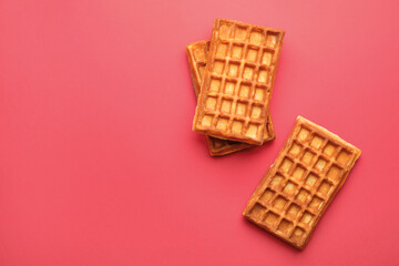 Delicious Belgian waffles on red background