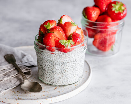 Jar of chia pudding topped with fresh strawberries