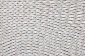 background of knitted texture of fabric of pale color or knitwear closeup