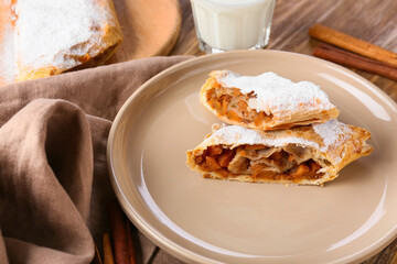 Plate with pieces of tasty pumpkin strudel on table, closeup