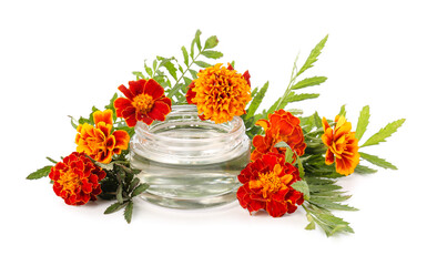 Obraz na płótnie Canvas Glass jar with essential oil of marigold flowers isolated on white background