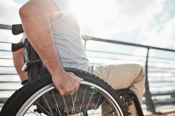 Side view close up of unrecognizable adult man in wheelchair outdoors lit by sunlight, copy space