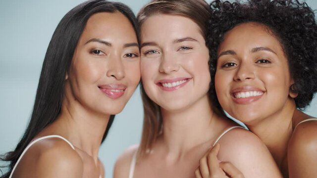 Beauty Portrait of Three Diverse Multiethnic Models on Isolated Background. Fun Joyful Asian, Black and Caucasian Women with Natural, Healthy Skin. Wellness, Spa, Cosmetology, Skincare Concept.