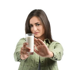 Young woman refusing to drink milk on white background