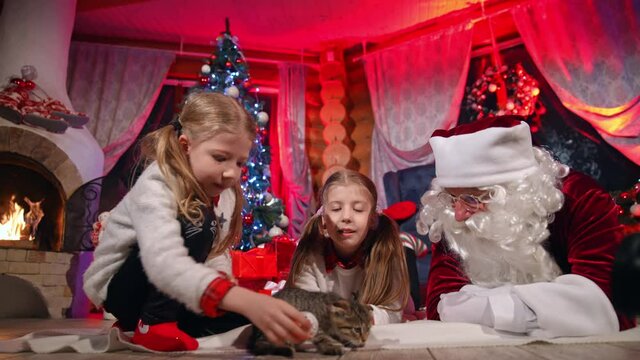 Lovely little girl indoors at Christmas. Cute children reading a letter to the Santa. Beautiful small girls spending time on xmas background at home