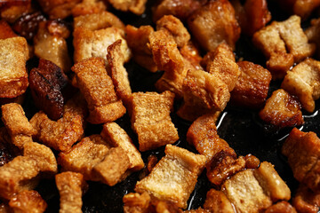 Tasty cracklings in frying pan