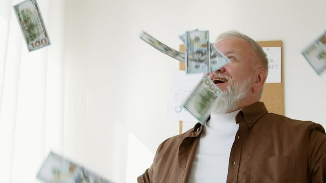 man watching money dollars fall in slow motion