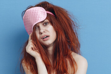 woman with tousled hair sleep mask posing close-up