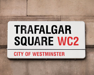 Sign indicating to the public they are in Trafalgar Square, best known for Nelson's Column, a huge monument towering the area at 169 feet and 3 inches, it's a tourist favorite and cultural hotspot. - obrazy, fototapety, plakaty