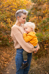 Fototapeta premium happy beautiful mother with her little son in the forest