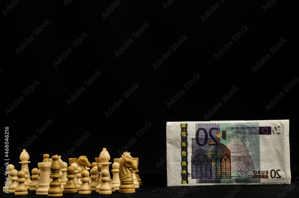 Sticker chessmen and euro banknote isolated on a black background