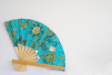 Silk Turquoise Print Fan on White Background with Room for Text