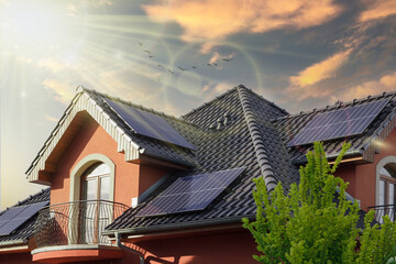 Modern house with solar panels in the sun. Concept clean power energy. SUNSET