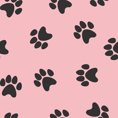 Fototapeta na wymiar black footprints of a cat on a pink background. seamless abstraction of animal footprints for clothing or print