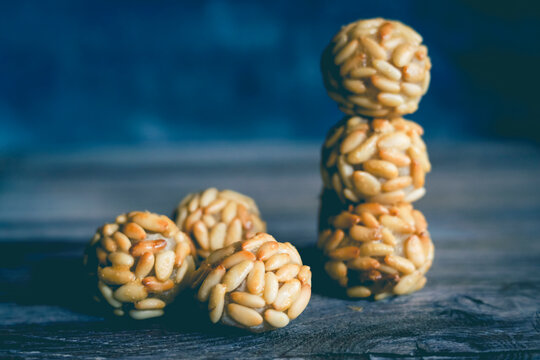 Stack of traditional Catalonian panellets with pine nuts on a table