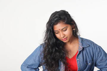 Young attractive Asian Indian woman pose face body expression mode emotion on white background think look down