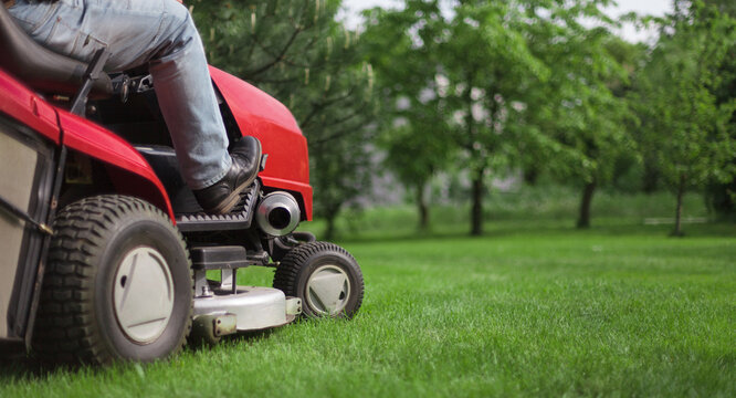 Close-up of an equestrian landscape architect on a lawn mower. Copy -space.