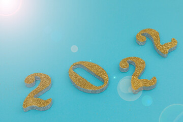 Happy new year 2022 gold color with blue background and flash of light