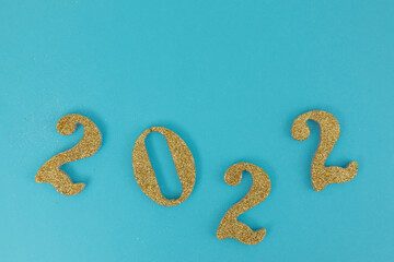Happy new year 2022 in gold color with blue background and space for text