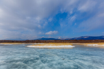 Beautiful ice of a frozen lake. Overall plan. Sikhote-Alin Biosphere Reserve in the Primorsky Territory.