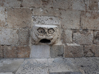 Maskeron gargoyle in Dubrovnik, Croatia represents good luck if people can remove their shirt while balancing on the stone. 