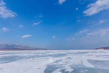 Beautiful ice of a frozen lake. Overall plan. Sikhote-Alin Biosphere Reserve in the Primorsky Territory.