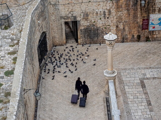 View looking down on old street from fortified wall surrounding city of Dubrovnik, Croatia. 