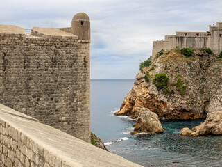 Ancient wall surrounding city of Dubrovnik, Croatia. Adriatic sea and fortress seen in the background