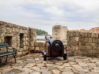 Canon pointing out to sea atop ancient city wall in Dubrovnik, Croatia.