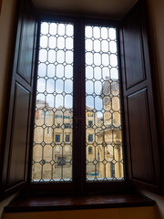 View through ancient leaded windows looking out to ancient buildings of Dubrovnik. 
