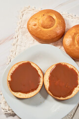 Mexican bisquet or biscuit bread, halved with caramel.