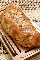 delicious bread with raisins on the wooden board