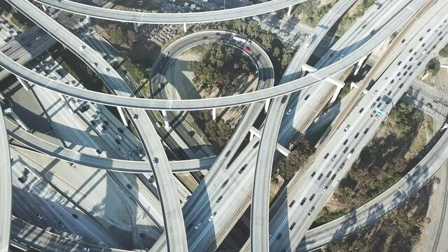Aerial view Los Angeles freeway, cars and trucks on road traffic on highway in LA. urban modern city in USA, travel destination in America. Drone 4k. 