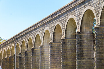 Architectural arches of an antique aqueduct in the main city of Guadalajara in Mexico

